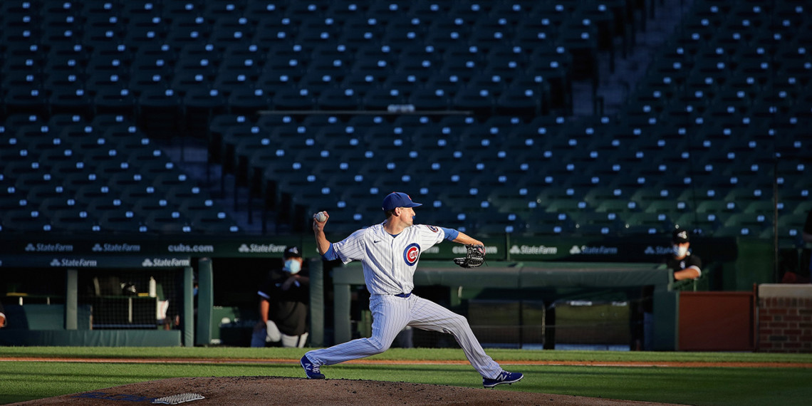 kyle-hendricks-cubs-PAGE-2020 a pitcher throwing a baseball in an empty stadium