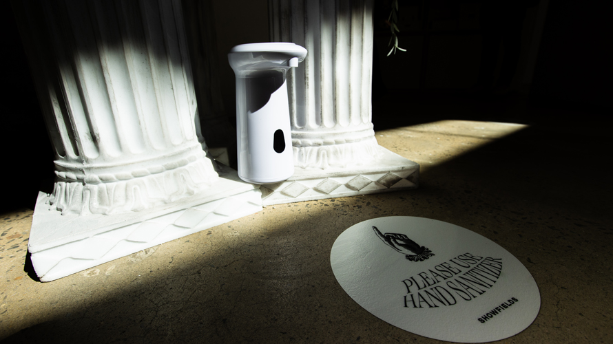 hand sanitizer station next to pillars