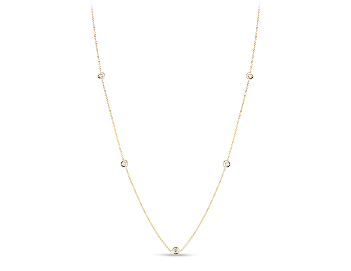 Roberto Coin round brilliant cut diamond bezel necklace in 18k yellow gold.