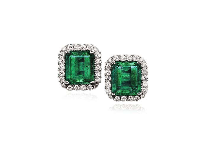 Emerald and round brilliant cut diamond earrings in 18k white gold.