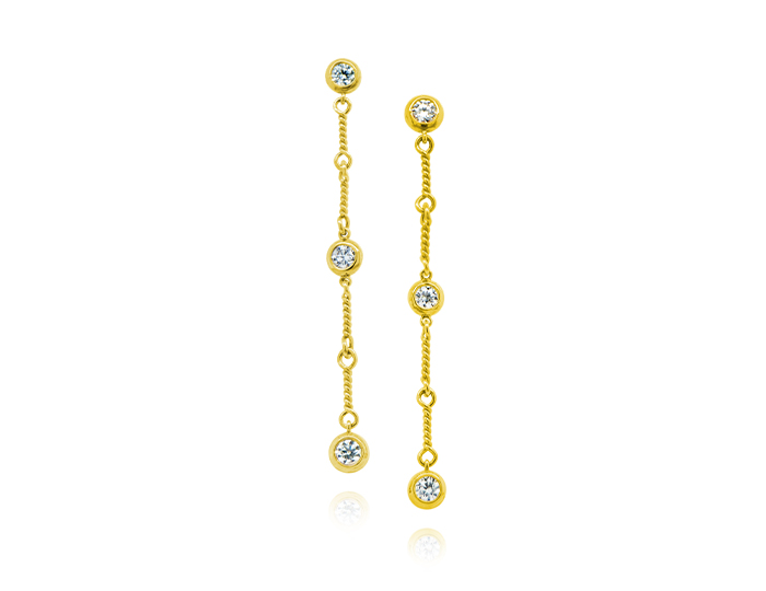 Round brilliant cut diamond dangle earrings in 18k yellow gold.