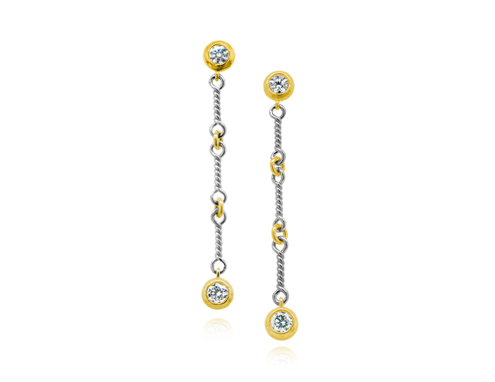 Round brilliant cut diamond earrings in 18k white and yellow gold.