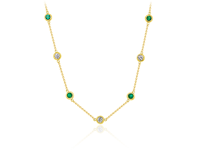 Emerald and round brilliant cut diamond necklace in 18k yellow gold.