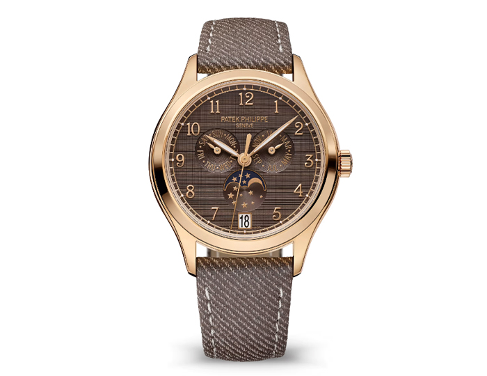 Patek Philippe Annual Calendar ref. 4946R-001 featuring a self-winding mechanical movement, "shantung" finish chestnut dial, and a 38mm 18k rose gold case on a calfskin strap with a prong buckle.