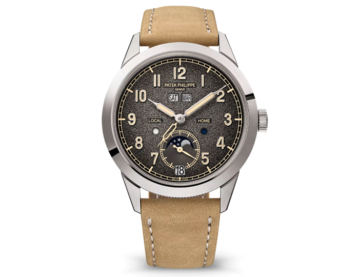 Patek Philippe Annual Calendar Travel Time ref. 5326G-001 featuring a self-winding mechanical movement, textured charcoal gray dial, and a 41mm 18k white gold case with a hobnail case-middle on a calfskin strap with a fold-over clasp.