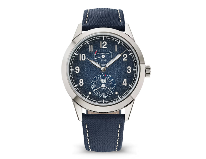 Patek Philippe ref. 5328G-001 featuring a manually wound mechanical movement with an eight-day power reserve and instantaneous day-date display inside a 41mm 18k white gold case with a hobnail case-middle on a calfskin strap with a fold-over clasp.