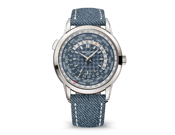 Patek Philippe World Time ref. 5330G-001 featuring a self-winding World Time movement with a date display indexed to local time, opaline blue-gray dial, and a 40mm 18k white gold case on a calfskin strap with a fold-over clasp.