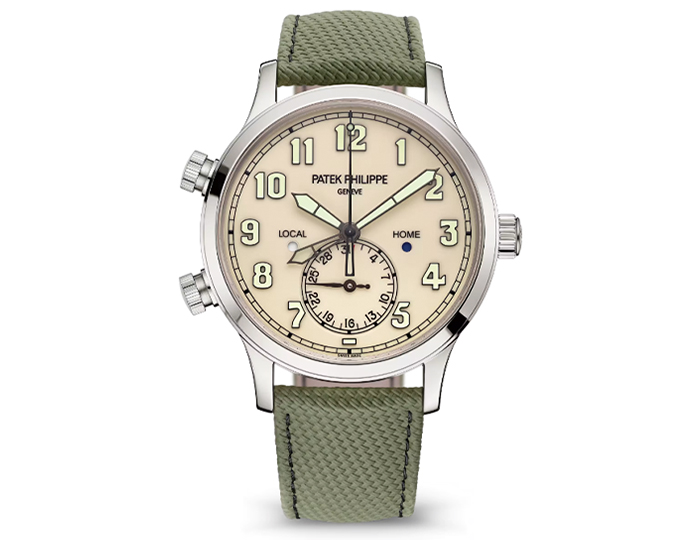 Patek Philippe Pilot Travel Time ref. 5524G-010 featuring a self-winding mechanical movement, ivory dial, and a 42mm 18k white gold case on a composite material strap with a clevis prong buckle.