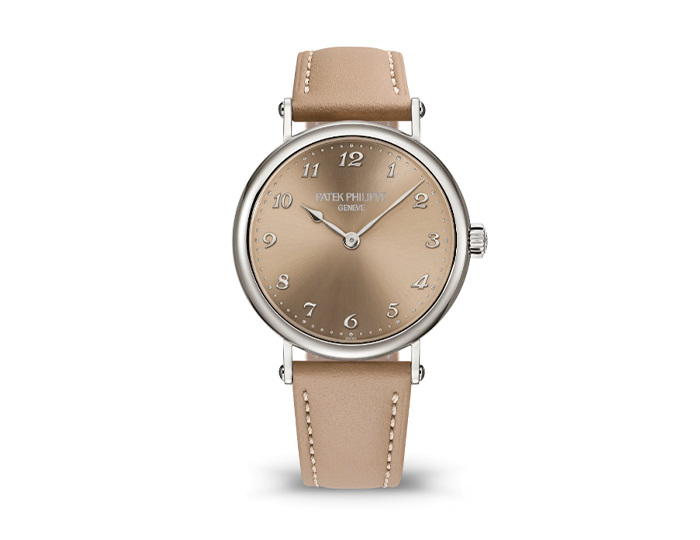 Patek Philippe Calatrava ref. 7200/50G-001 featuring a self-winding movement, sunburst sand beige dial, and a 34.6mm 18k white gold case on a calfskin strap with a prong buckle.