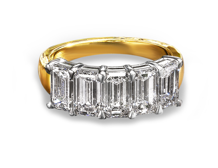 Emerald cut diamond band in 18k white and yellow gold.