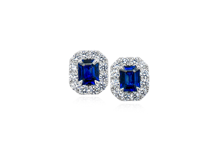 Emerald cut sapphire and round brilliant cut diamond earrings in 18k white gold.