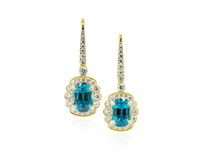 Oval blue zircon and round brilliant cut diamond earrings in 18k yellow gold.