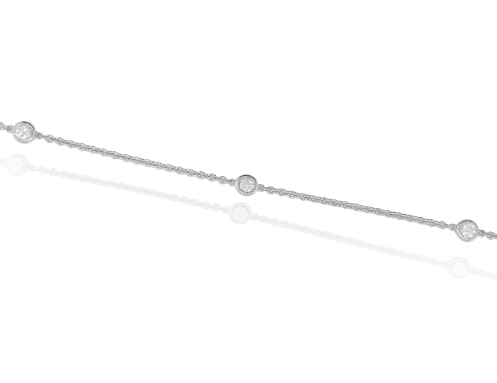 Round brilliant cut diamond bezel bracelet in 18k white gold.