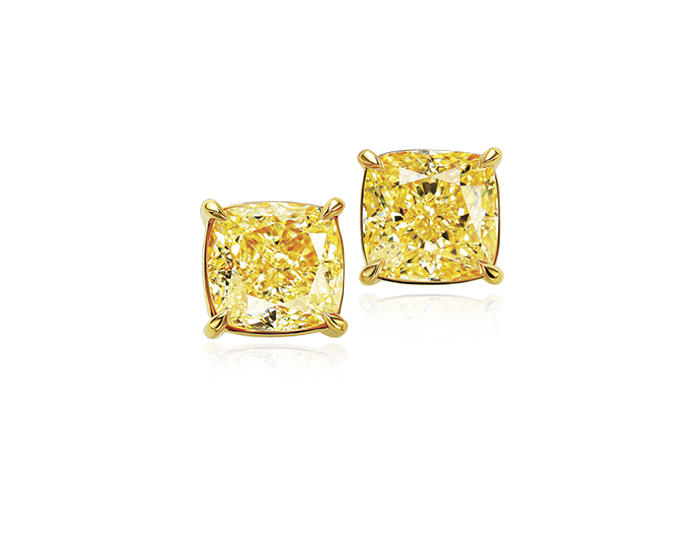 Cushion cut fancy yellow diamond earrings in 18k yellow gold.