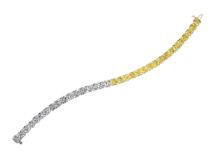 Fancy yellow diamond and cushion cut diamond bracelet in platinum and 18k yellow gold.