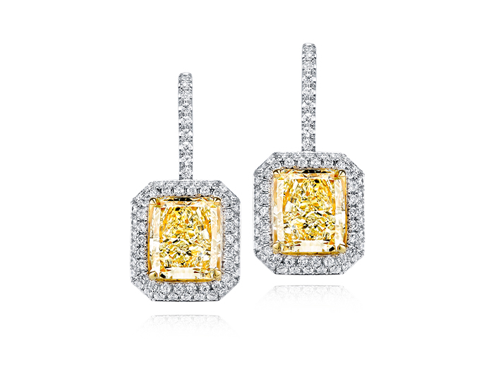 Fancy light yellow diamond and round brilliant cut diamond earrings in 18k white and yellow gold.