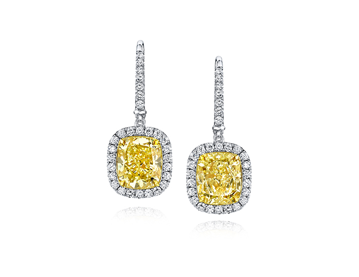 Fancy yellow diamond and round brilliant cut diamond earrings in platinum and 18k yellow gold.