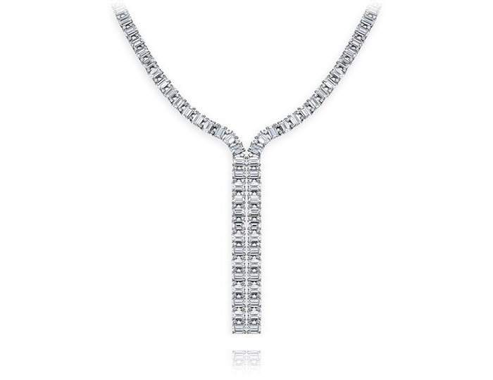 Emerald and round brilliant cut diamond lariat necklace in 18k white gold.