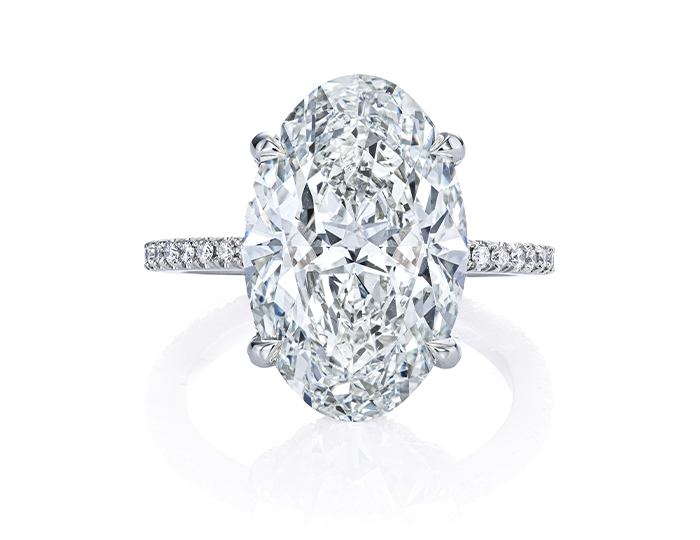 Oval and round brilliant cut diamond engagement ring in platinum.