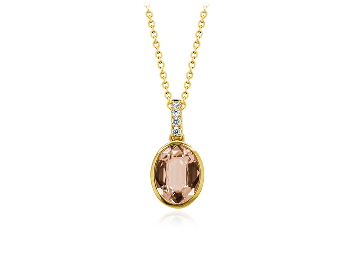 Oval cut morganite and round brilliant cut diamond pendant in 18k yellow gold.