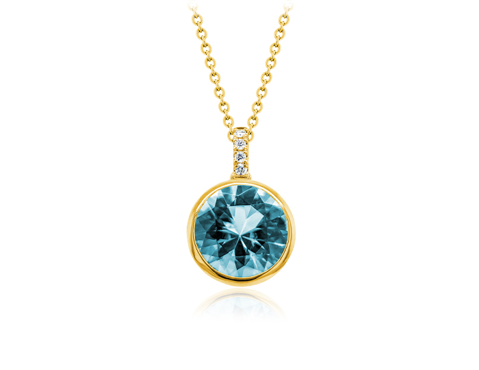 Round cut aquamarine and round brilliant cut diamond pendant in 18k yellow gold.