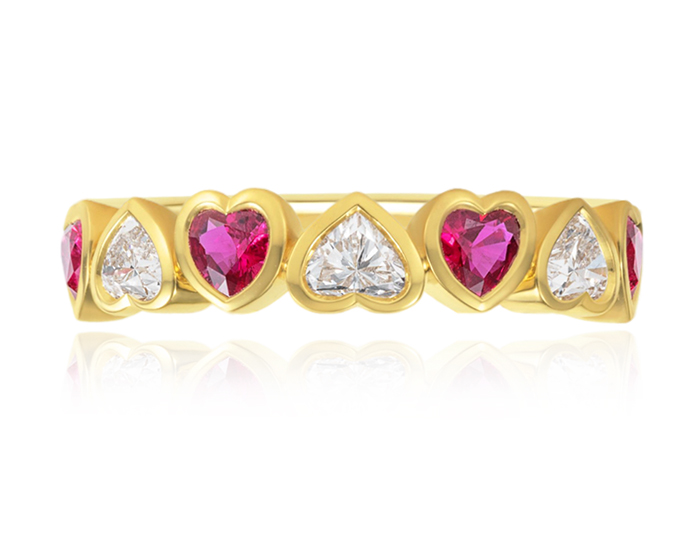 Ruby and heart shaped diamond ring in 18k yellow gold.