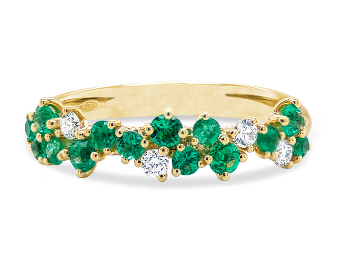 Emerald and round brilliant cut diamond ring in 18k yellow gold.