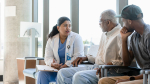 a doctor talking to an elder patient and his son 