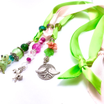 Three chains of beads hanging from ribbon