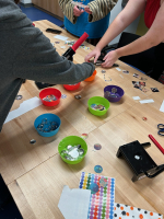 a group of teens making buttons