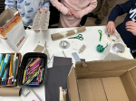 group of kids making cardboard crafts