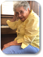 older woman sitting at a piano