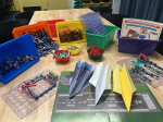 A table of workshop materials including snap circuits, paper airplanes and more