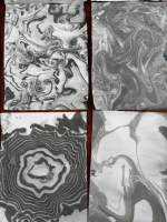 black and white photo with four paper marbling pieces
