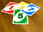 four UNO cards on a table