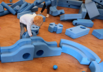 a child playing with big blue blocks