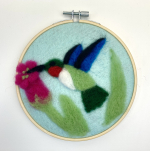 soft felted bird in an embroidery hoop
