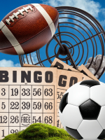 A soccer ball and a football rest in front of a blue sky background and a bingo cage.