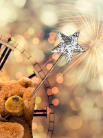 A fluffy tan-colored teddy bear holds a sparkly silver wand; part of an analog clock is set against