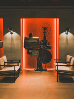 chairs facing each other with film reel device in between