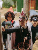 Three children in Halloween costumes.