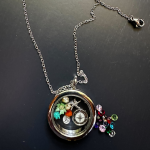 Circle clear locket with a variety of charms inside