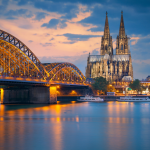 An evening view of the famous Hohenzollernbrucke bridge over the Rhine River in Cologne, Germany
