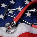 American Flag with Stethoscope laying on top of it