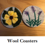 two wool coasted, one with a yellow flower, the other with 3 purple flowers