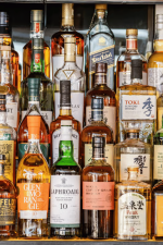 bottles of alcohol on a shelf in a bar