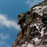 Old Man of the Mountain with blue sky behind him