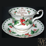 Festive teacup on black background with words inside the cup reading "A Cup of Christmas Tea"