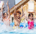 Three children playing in a pool