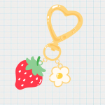 strawberry and daisy charms on a yellow clip key chain on a graph paper background.